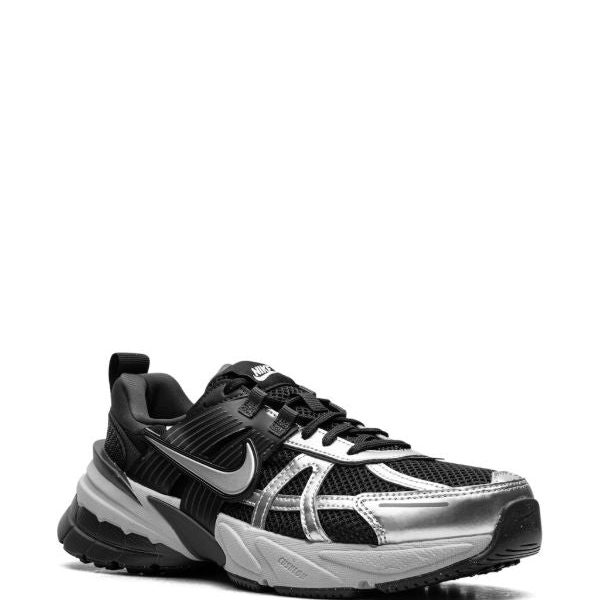 Black and metallic-silver Nike running shoe with a mesh upper, white swoosh, and thick cushioned sole.