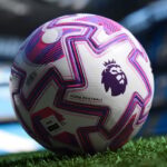 rn-image_picker_lib_temp_04315544-2b0c-4cc6-b144-551efece61e3 | UAE SPORT STORE Soccer ball on grass with pink-purple geometric panels and Premier League logo visible
