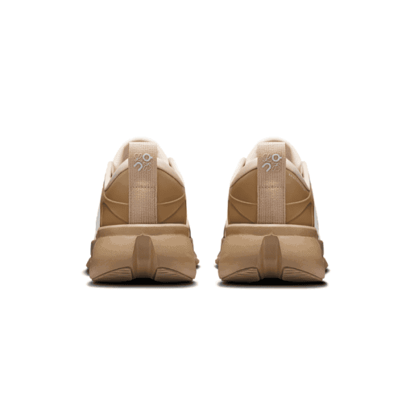 Rear view of two tan sneakers side by side on a white background, showing pull-tabs with logos.