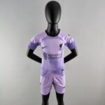 rn-image_picker_lib_temp_122e0763-2253-4c7b-90ab-e4f3b64cd3f0 | UAE SPORT STORE Back view of a black mannequin wearing a lavender Liverpool football jersey and shorts, with logos visible on chest and sleeve.