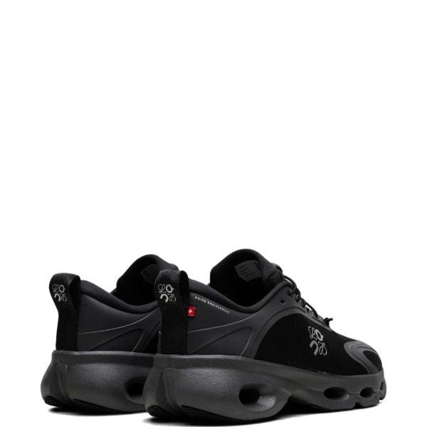 Pair of black athletic sneakers with chunky soles and pull tabs, shown from the rear-left on a white background.