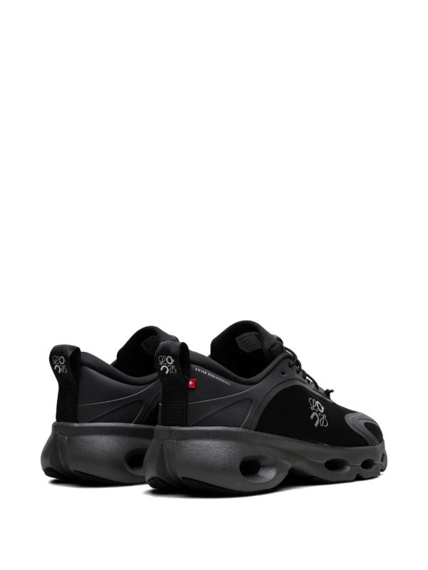 rn-image_picker_lib_temp_1737eb3d-fddb-4be0-bc59-fd33724bb95b | UAE SPORT STORE Pair of black athletic sneakers with chunky soles and pull tabs, shown from the rear-left on a white background.