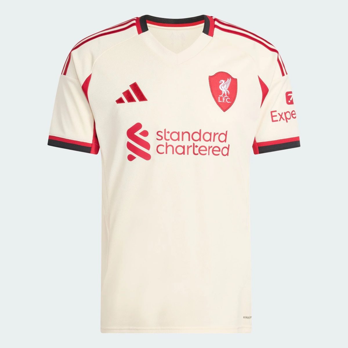 White Liverpool FC jersey with red crest, Adidas logo, and Standard Chartered sponsor across chest on pale background.