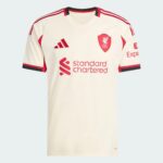 White Liverpool FC jersey with red crest, Adidas logo, and Standard Chartered sponsor across chest on pale background.