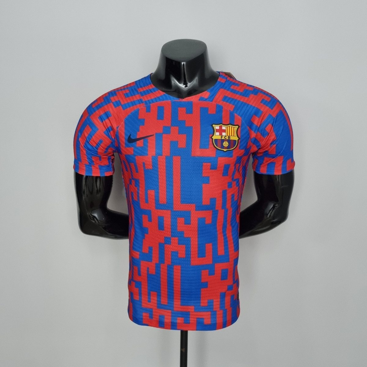 Black mannequin torso wearing a blue and red FC Barcelona jersey on a stand, headless.