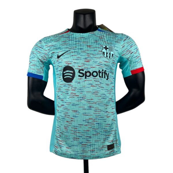 Turquoise soccer jersey on a mannequin with Spotify sponsor logo and club crest visible on the chest area.