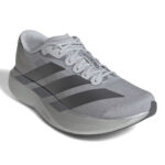 rn-image_picker_lib_temp_2f2a1ca5-8fe6-421e-9b93-ad88cca4c470 | UAE SPORT STORE Gray Adidas running shoe with three dark stripes, light laces, and a curved outsole, angled view.