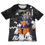 Black T-shirt with a bold, colorful Gundam robot graphic, hexagon patterns, and Japanese text across the bottom.