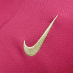 rn-image_picker_lib_temp_37655ca5-fa5b-4155-a52a-3258d4007f2f | UAE SPORT STORE Gold Nike swoosh embroidered on bright pink fabric.