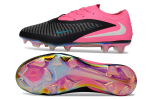 Nike soccer cleat with pink heel, black striped upper, light blue swoosh, and iridescent outsole shown from side and bottom (product image).