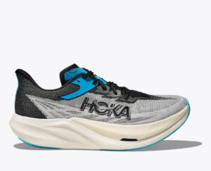 rn-image_picker_lib_temp_39de32c9-32c7-4026-b710-c0ae62d5ead2 | UAE SPORT STORE Side view of a gray and black HOKA running shoe with blue accents and a thick white sole, brand name visible on the side.