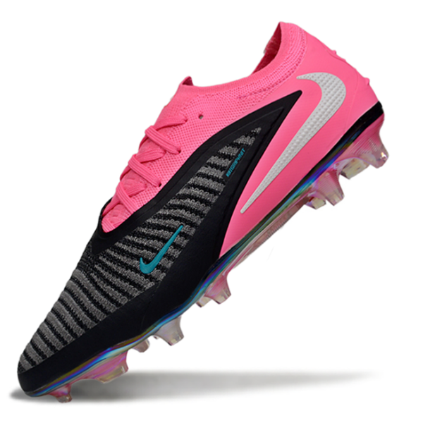 Bright pink and black Nike soccer cleat with a striped gray upper and turquoise swoosh, angled as if in midair.