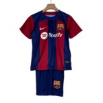 Blue and red FC Barcelona soccer jersey hanging on a wooden hanger, featuring the Nike logo and Spotify sponsor across the chest.