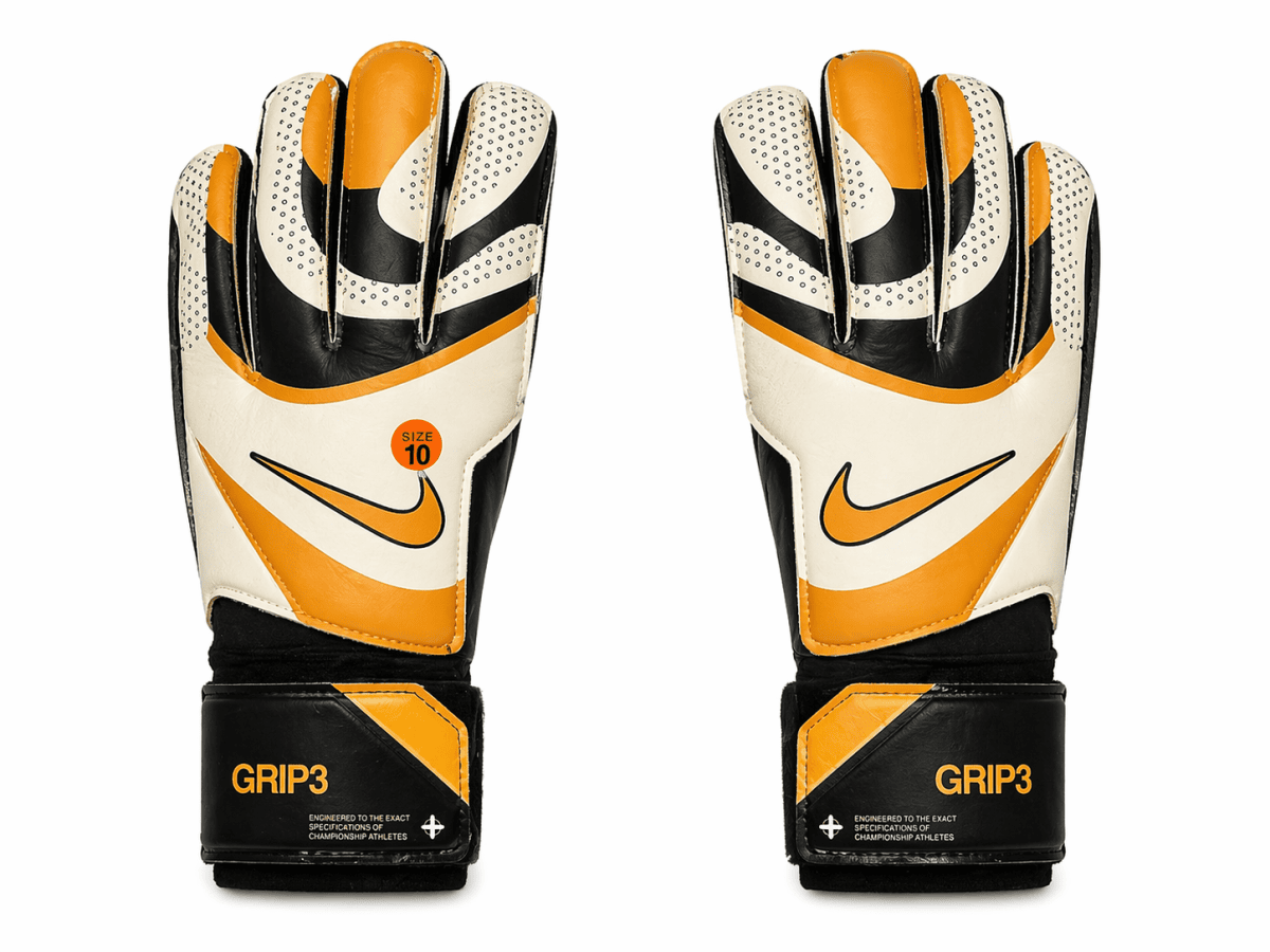 Pair of white, black, and orange goalkeeper gloves shown frontward, featuring a Nike swoosh and size 10 badge on the palm area.