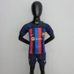 rn-image_picker_lib_temp_47282d69-1920-49ac-bb63-d5f098bd5295 | UAE SPORT STORE Life-size black mannequin wearing a blue and red FC Barcelona jersey, standing against a plain wall.