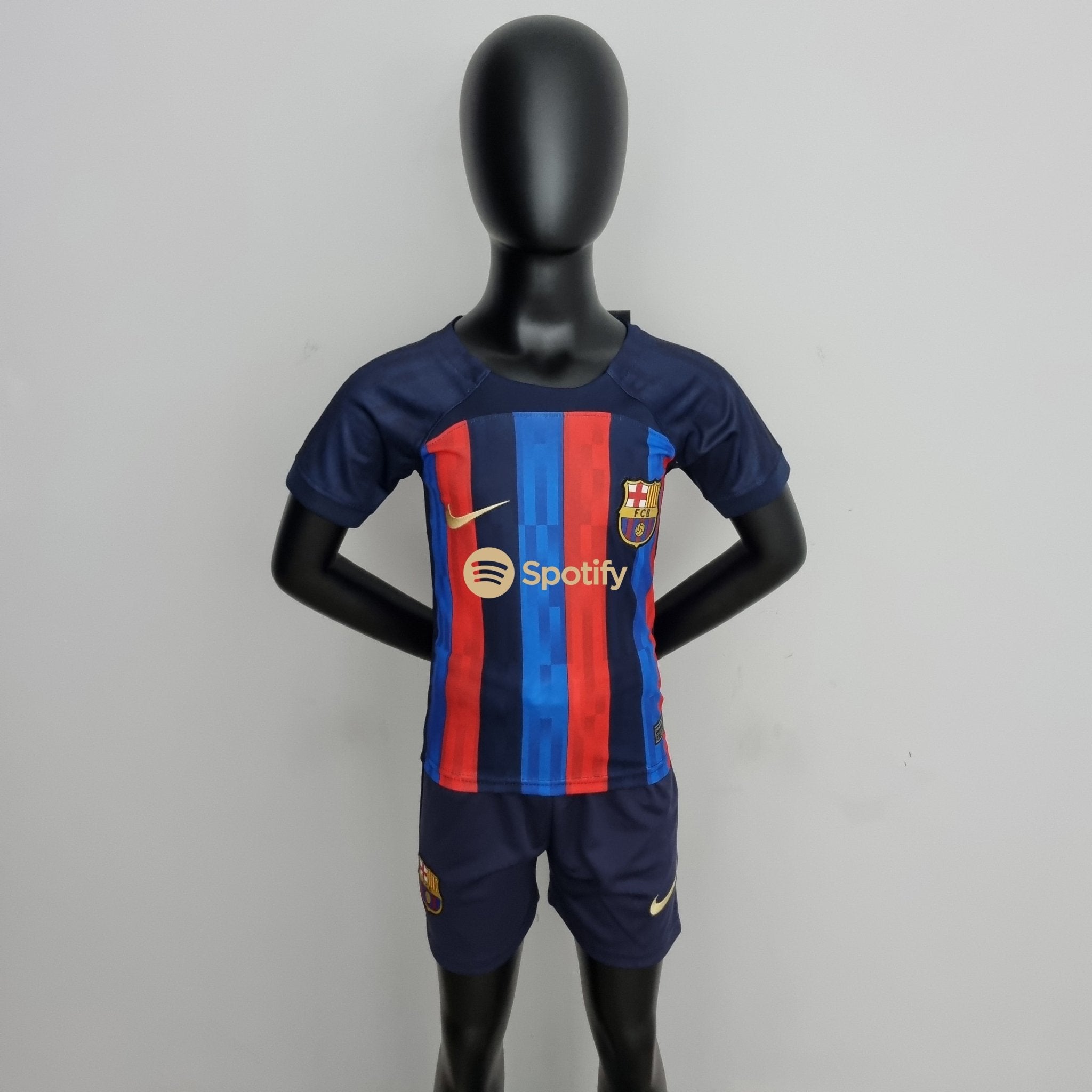 rn-image_picker_lib_temp_47282d69-1920-49ac-bb63-d5f098bd5295 | UAE SPORT STORE Life-size black mannequin wearing a blue and red FC Barcelona jersey, standing against a plain wall.