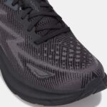 Close-up of a dark gray knit running shoe with black laces and a patterned upper.
