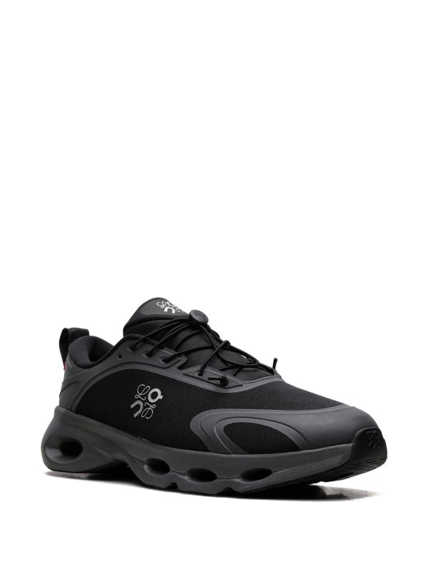 rn-image_picker_lib_temp_4869a66e-b3a7-49dd-90eb-41b42d37685b | UAE SPORT STORE Black athletic sneaker with gray accents and a chunky sole, lace-up front, and side logo.