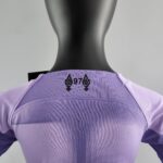 rn-image_picker_lib_temp_4fa8da71-80e9-4919-9860-e3ec7c95e812 | UAE SPORT STORE Back view of a black mannequin wearing a lavender T-shirt with a small black graphic of two pendant-like symbols.