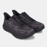 Pair of dark gray running shoes with patterned knit upper and chunky black soles on a light background, angled view.