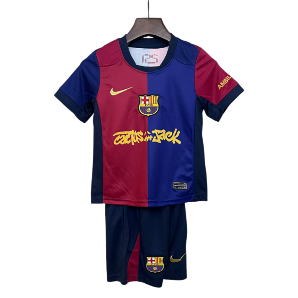 Red and blue FC Barcelona jersey on a hanger against a white background, displaying the club crest and gold Nike swoosh on the chest area
