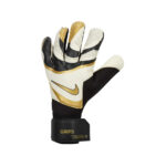 Nike goalkeeper glove in white, black, and gold with a gold swoosh and Velcro wrist strap marked GRIP3.