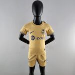 Black mannequin wearing a yellow FC Barcelona soccer jersey with Nike logo and Spotify sponsor text and emblem, front view.
