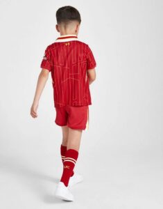 rn-image_picker_lib_temp_55830938-c0c7-4a78-8063-e14f90aa5894 | UAE SPORT STORE Child wearing a red Liverpool FC soccer kit, back view with patterned jersey, red shorts, and matching red socks.