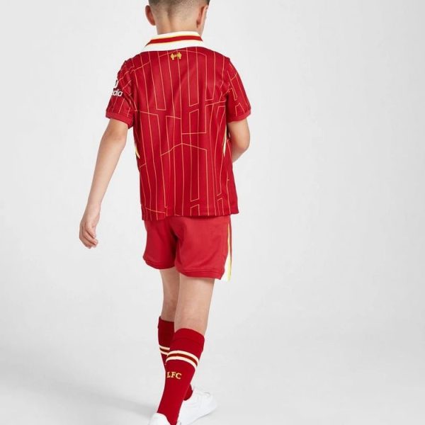 Child wearing a red Liverpool FC soccer kit, back view with patterned jersey, red shorts, and matching red socks.