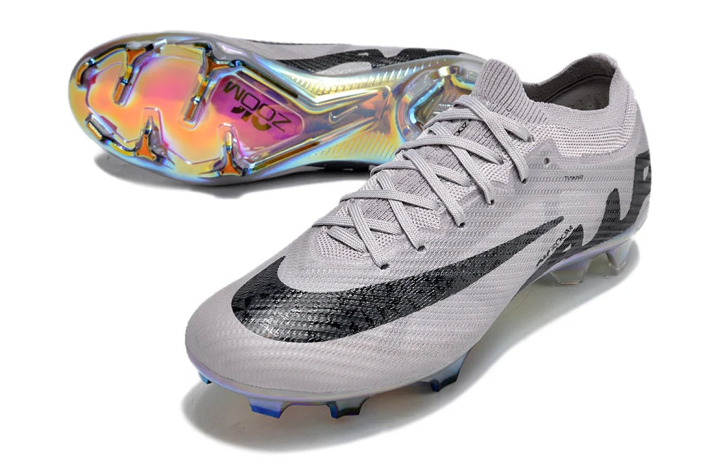 rn-image_picker_lib_temp_57b50515-7bf9-46b5-a2d4-25bea8aa3d83 | UAE SPORT STORE Light gray soccer cleats with a black Nike swoosh and iridescent multi-color soleplate