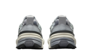 Rear view of two gray running shoes placed side by side on a plain background with chunky midsoles and pull tabs