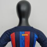 rn-image_picker_lib_temp_5be644b8-98a2-403a-a5d5-92d968db7b93 | UAE SPORT STORE Mannequin torso wearing a navy blue top with bold vertical red and blue stripes and color blocks on the chest area.