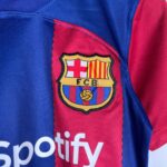 Close-up of the FC Barcelona crest on a blue-and-red jersey fabric.