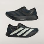 Close-up side view of a black athletic sneaker with a chunky platform sole and diagonal stripes.