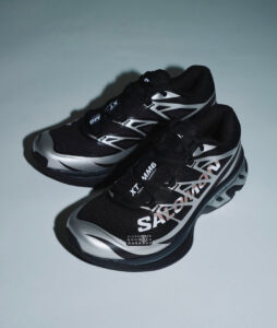 rn-image_picker_lib_temp_6870b7e6-6e26-41bc-b2e1-ad93f01d0929 | UAE SPORT STORE Pair of black and silver running shoes with bold white geometric graphics, resting on a light gray background.