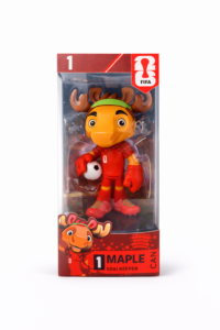 Toy figure in red soccer goalie outfit inside packaging, holding a white soccer ball; featured branding includes FIFA logo and 'MAPLE CAN' text on the box.