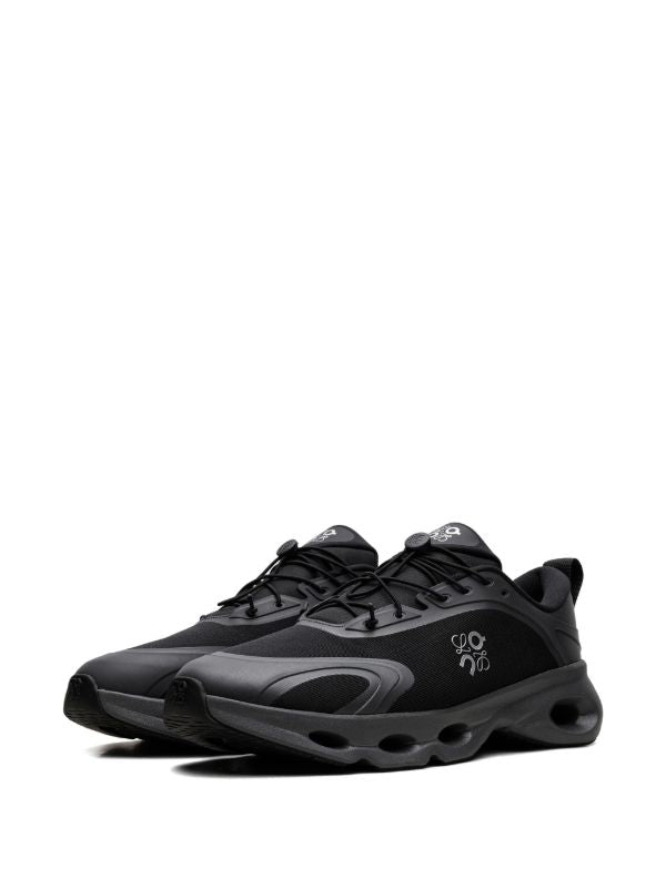 rn-image_picker_lib_temp_6faa22bf-8bd5-4672-bfe7-50bbee37713e | UAE SPORT STORE Pair of black athletic running shoes with a vented mesh upper and thick cushioned soles, shown from a side angle.