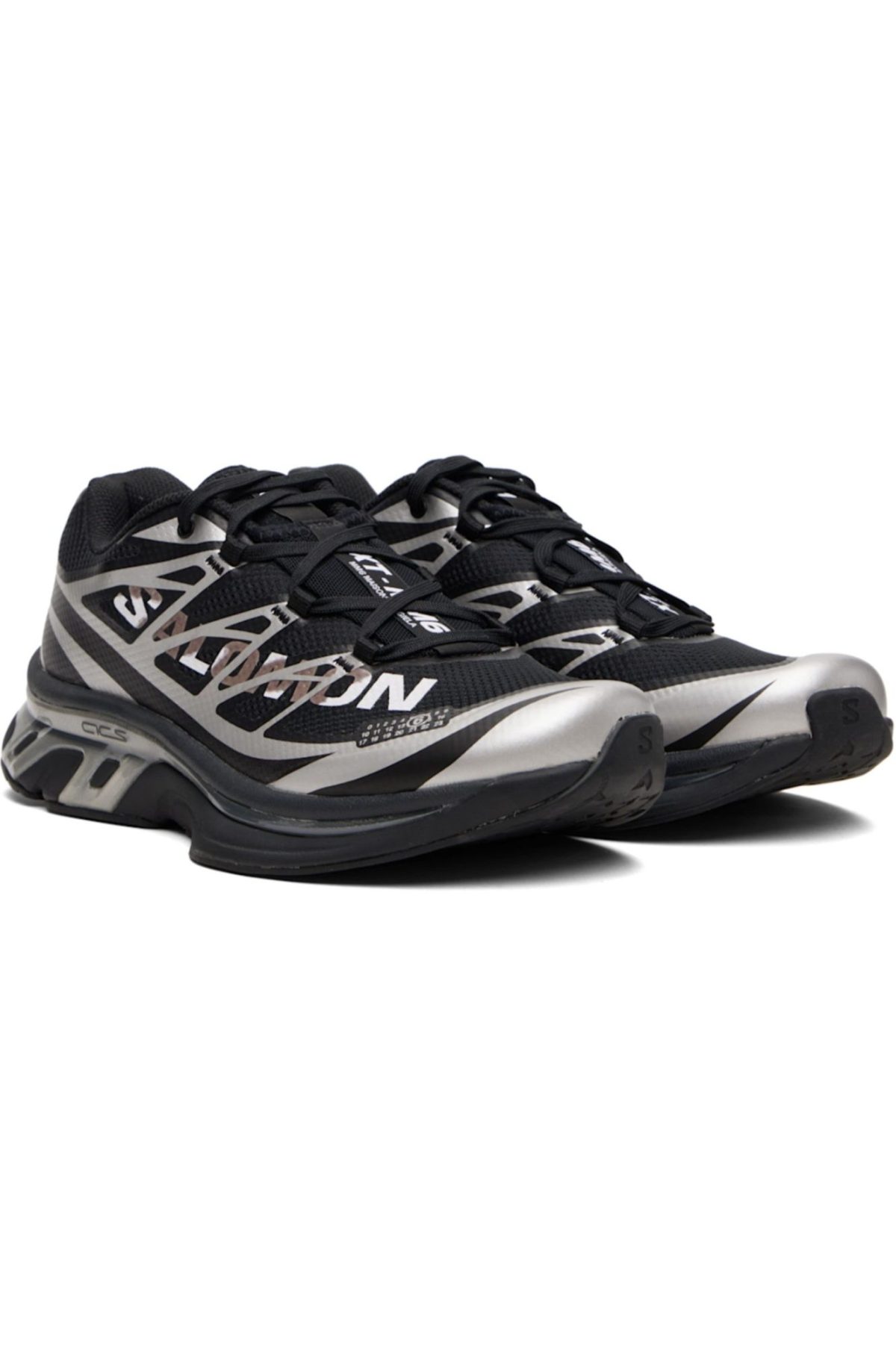 Pair of black and silver running shoes with a geometric pattern and thick soles.