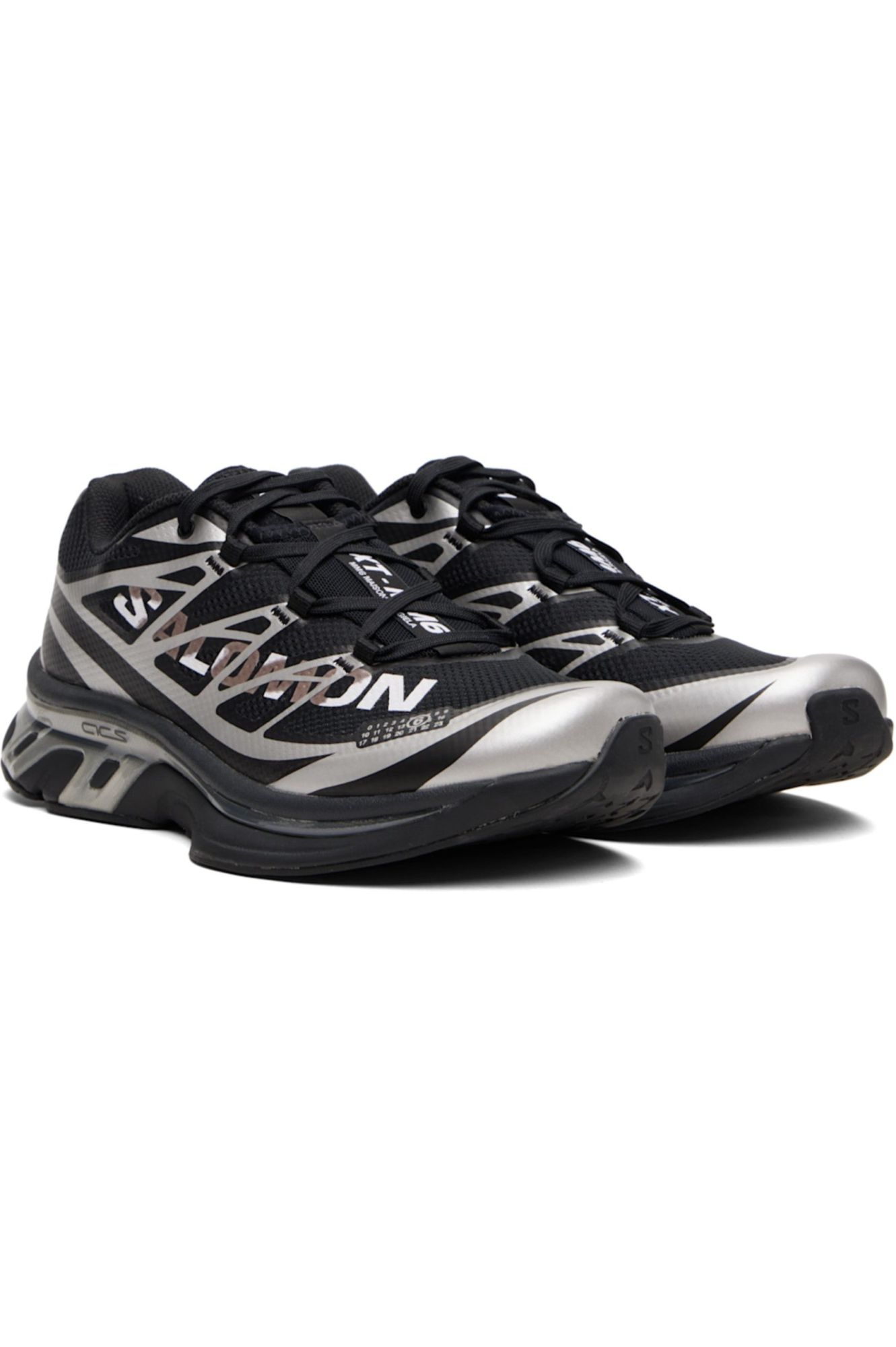 rn-image_picker_lib_temp_7360720c-1a8b-4715-a5ee-d5e066289c86 | UAE SPORT STORE Pair of black and silver running shoes with a geometric pattern and thick soles.