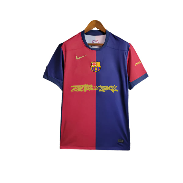 Barcelona football jersey split red and blue on a hanger; features Nike swoosh, club crest, and yellow sponsor text across the chest.