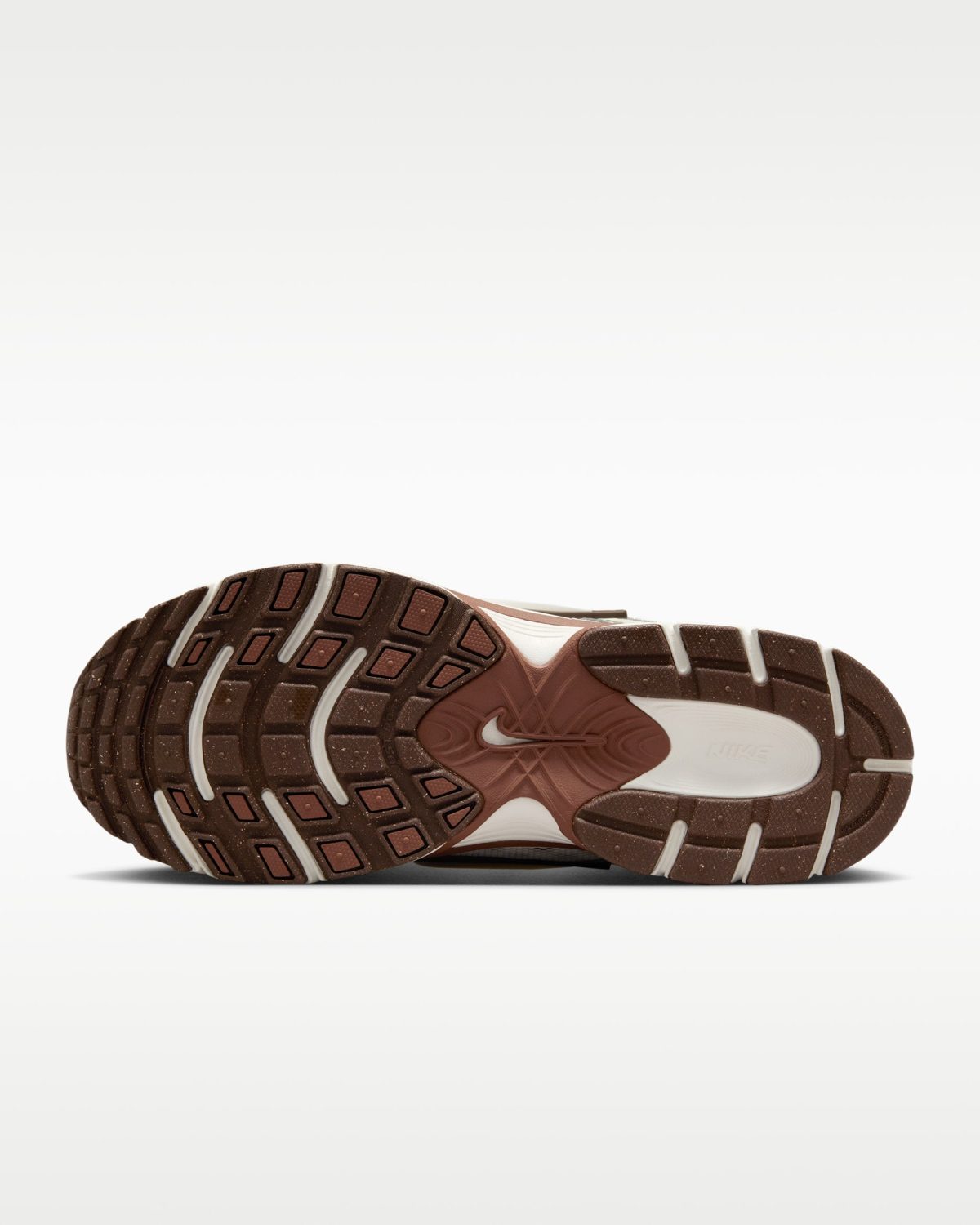 Bottom view of a brown and white athletic shoe sole with a textured tread pattern.