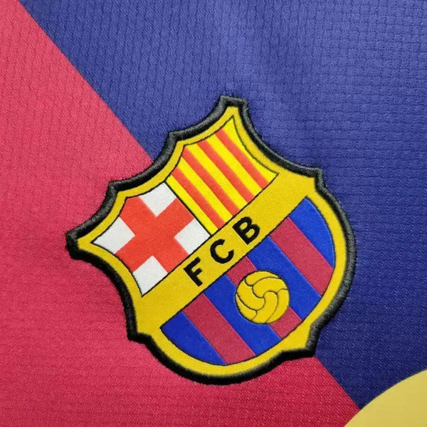 rn-image_picker_lib_temp_82a6152c-779d-4a0b-9035-6632936af2cc | UAE SPORT STORE Barcelona football club crest placed on a diagonal red and blue background, featuring the yellow and red stripes and shield emblem with a ball.