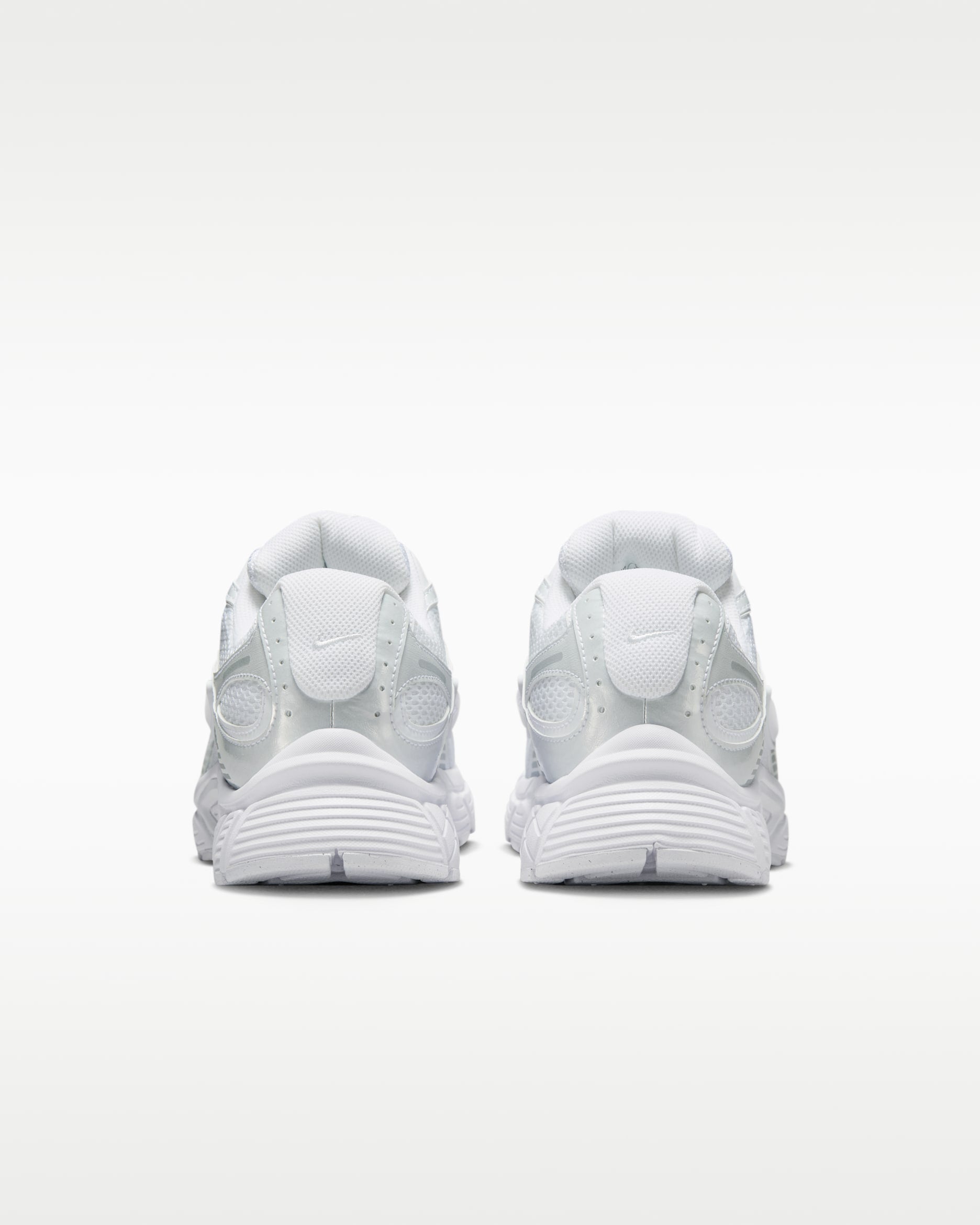 rn-image_picker_lib_temp_83466c0b-87d1-4c94-aa49-ad5c00b7f865 | UAE SPORT STORE Front view of two white athletic sneakers placed side by side on a pale gradient background.