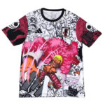 Colorful graphic T-shirt featuring an anime-style muscular character with a bright pink fluffy cape against a black-and-white background, plus a small Japan emblem on the chest.
