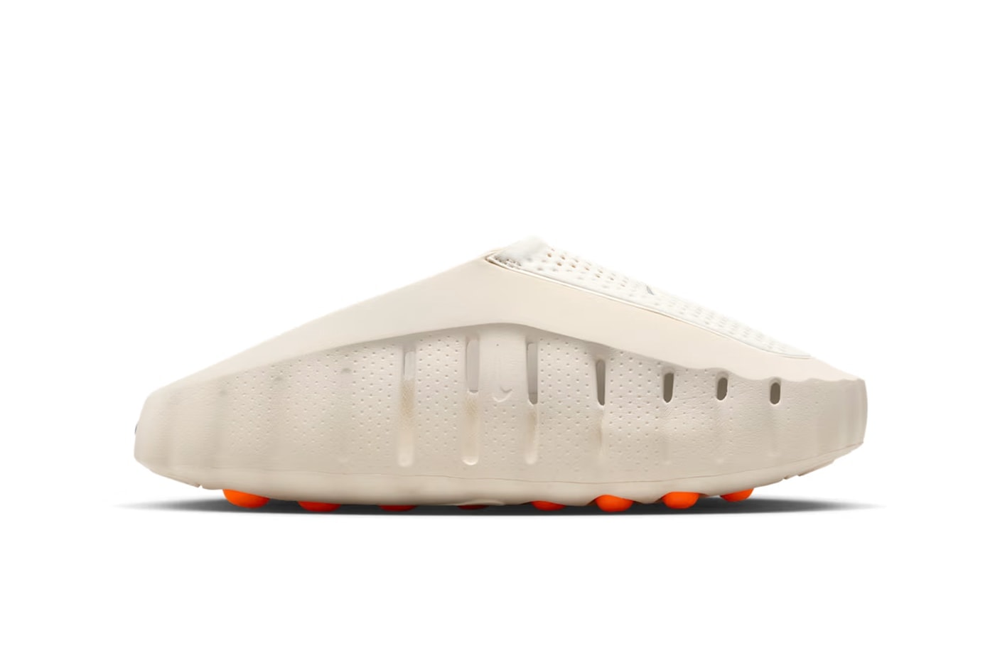 rn-image_picker_lib_temp_88d75094-9ce3-468e-8b41-7db40600dda7 | UAE SPORT STORE White low-profile sneaker with a perforated upper and orange studs visible on the sole (side view).