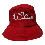 Red bucket hat with white embroidered Arabic text on the front.