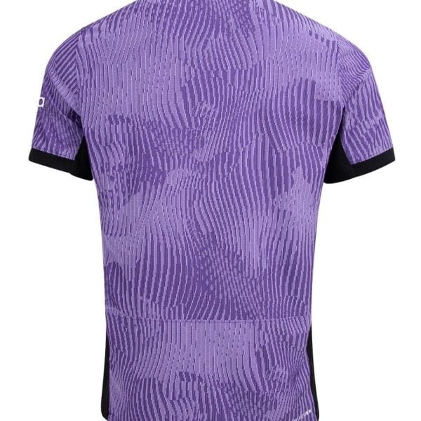 Back view of a purple camouflage-pattern cycling jersey with black sleeve cuffs and subtle vertical texture