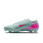 Mint green Nike soccer cleat with pink swoosh and magenta heel detail on a white background.