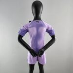 rn-image_picker_lib_temp_a5e2f85e-66ee-4725-8c06-76205d4b30ad | UAE SPORT STORE Back view of a black mannequin wearing a lavender athletic jersey; arms are crossed in front of the torso.
