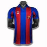 rn-image_picker_lib_temp_a934796d-0a90-4cf7-8d10-7905d4f94bb4 | UAE SPORT STORE Red and blue vertically striped soccer jersey on a black mannequin, with club crest on the left chest and a sponsor logo on the right chest.